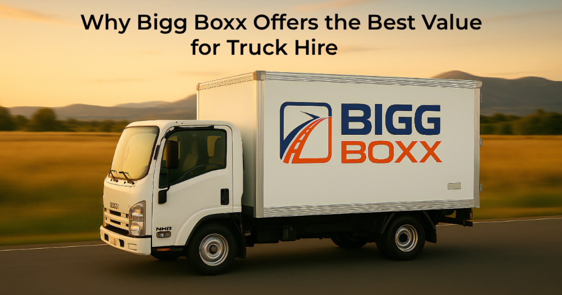 Side view of a white Bigg Boxx rental box truck driving on a road during a golden sunset | Why Bigg Boxx Offers the Best Value for Truck Hire | Bigg Boxx Rentals