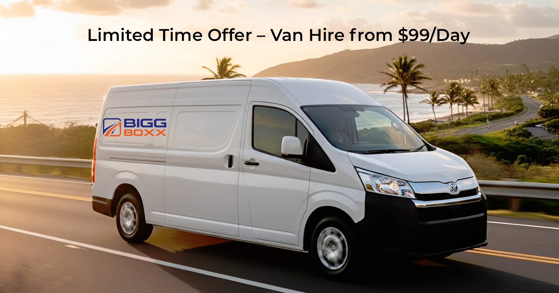 A white delivery van with the 'BIGG BOXX' logo on its side drives along a scenic coastal highway at sunset, with palm trees and the ocean visible in the background | Limited Time Offer – Van Hire from $99/Day | Bigg Boxx Rentals