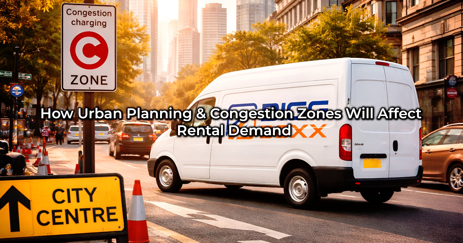A white BIGG BOXX rental van driving through a busy city street, passing a prominent "Congestion Charging C ZONE" sign and a "CITY CENTRE" directional sign, illustrating the impact of urban planning on vehicle rental demand | How Urban Planning & Congestion Zones Will Affect Rental Demand | Bigg Boxx Rentals
